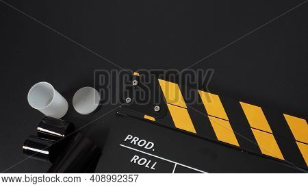 35mm Color Print Film And Clapper Board Or Movie Slate On Black Background. It Use In Movie And Vide