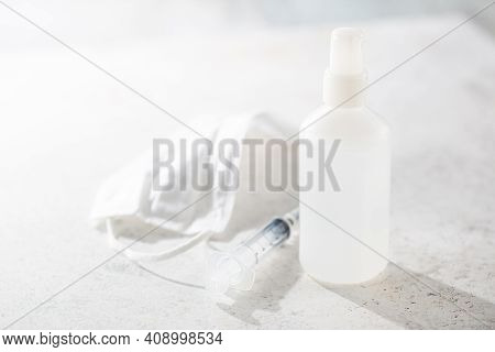 Medical Surgical Mask, Syringe And Bittles On White Background