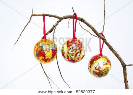 Three Christmas Decorations On A Dry Branch