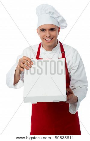 Young Chef Looking At Delicious Pizza
