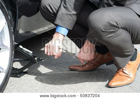 Man Repairing His Car Roadside