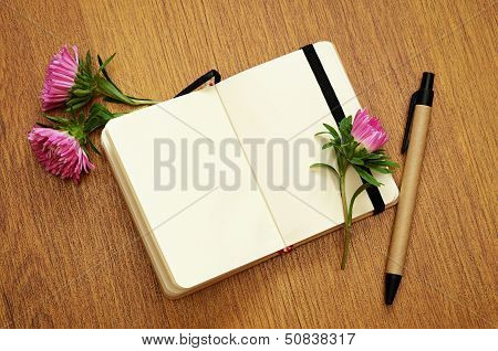 Aster Buds On A Notebook