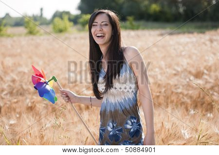 Happe young woman with windmill