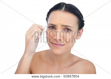 Suffering young model using tweezers on white background