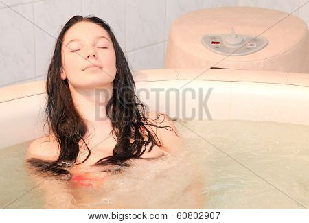 Pretty girl in the small jacuzzi