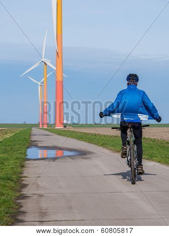 Mountain biker riding near wind turbine
