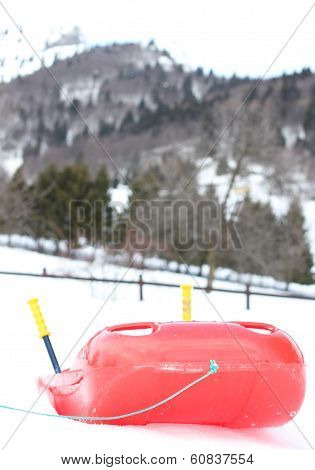 Red Bob Made Of Plastic On White Snow For Fun Rides On The  Mountain In Winter