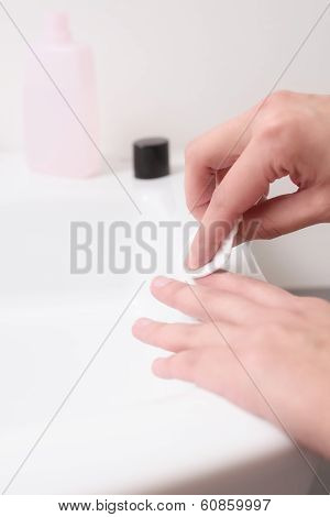 Woman Removing Nail Varnish With Acetone