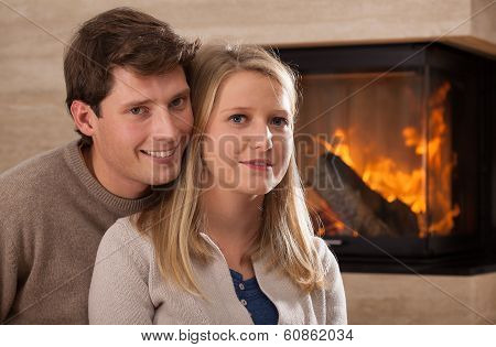 Young Couple By Fireplace