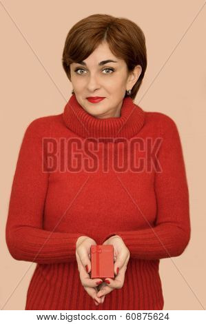Woman in red holding a gift