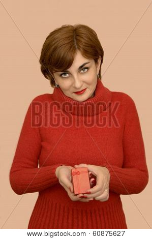 Woman in red holding a gift