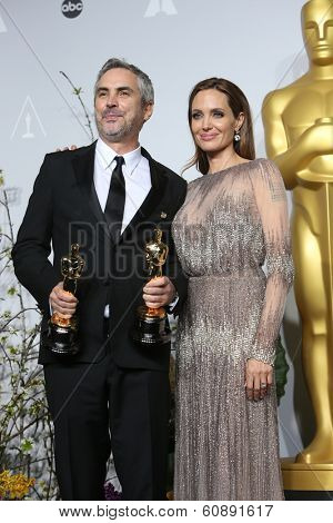 LOS ANGELES - MAR 2:  Alfonso Cuaron, Angelina Jolie at the 86th Academy Awards at Dolby Theater, Hollywood & Highland on March 2, 2014 in Los Angeles, CA