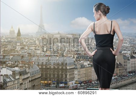 Young elegant woman looking on Paris with Eiffel tower