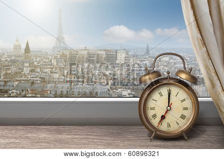 View of Paris and Eiffel tower from window with alarm clock
