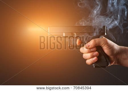 shot from a handgun with fire and smoke