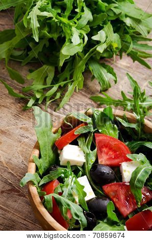 Greek Salad In A Wooden Salad Bowl On The Table