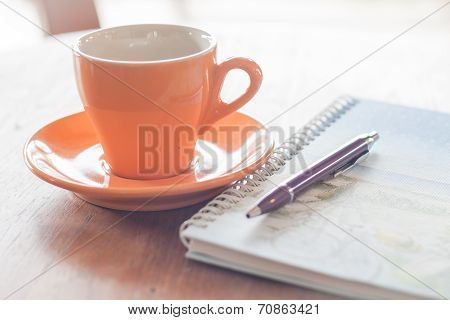 Cup Of Coffee With Pen And Spiral Notebook