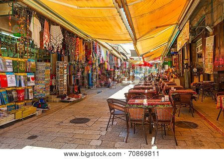 JERUSALEM, ISRAEL - JULY 10, 2014: Market in Muristan - complex of streets, shops and restaurants in Christian quarter of Old City. It is very popular with tourists and pilgrims visiting Holy Land.