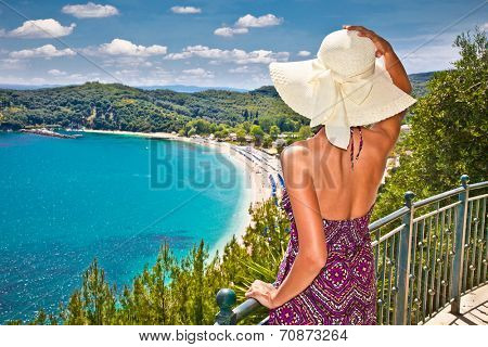 Beautiful woman looking on Valtos beach near Parga town of Syvota area in Greece.