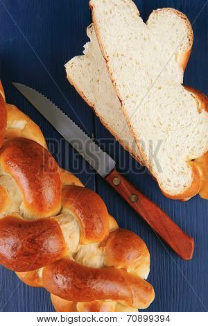 sweet bread : golden challah cuts over blue wooden plate