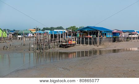 PULAU KETAM, MALAYSIA - JANUARY 18, 2015: A fishermen's boat docks close to his home on stilts in a village on Pulau Ketam (Crab Island). This island is famous for sea food products and restaurants.