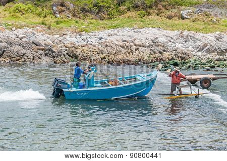 Crayfish Boat Being Pulled Onto Trailer At Kleinmond Harbor.