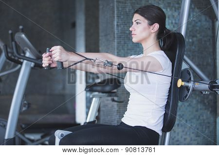 Fitness,sport lifestyle concept.Dedicated woman doing exercises with expander in gym.Fitness girl