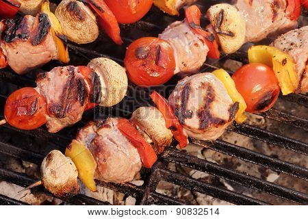 Pork And Vegetables Skewers Cooking On Bbq Grill