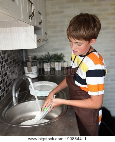 boy doing the dishes