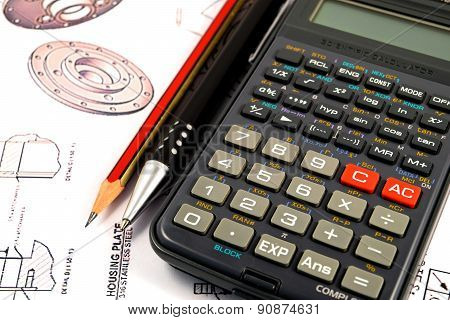 Scientific calculator, Pen and Pencil over the Engineering Drawing Map