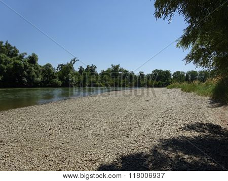 On the bank of the river.