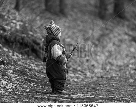 Little Caucasian Boy Playing In Forest At Early Spring