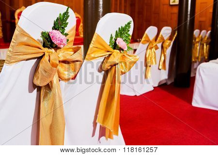 The back of yellow and gold wedding chairs