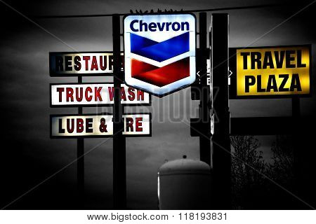 BARSTOW, UNITED STATES - DECEMBER 22: In the night light shining neon signs of different brands and restaurants with sedentary birds on the fixtures on December 22, 2015 in Barstow.