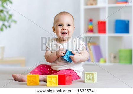 baby toddler playing color toys at home or nursery