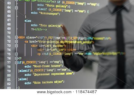 Man Pointing On Virtual Screen With Website Programming Code