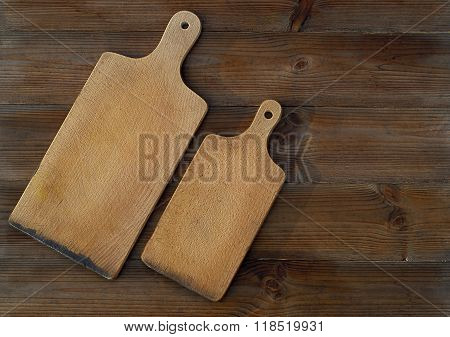 top view of wooden cutting boards on old wooden table