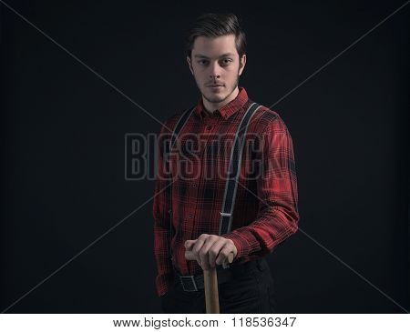Young Fashionable Farmer In Red Checkered Shirt Holding Hayfork.
