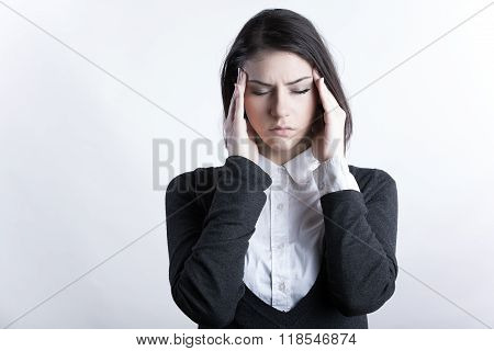 Young woman holding her head.Migraine and headache problem.Overworked,stressed woman