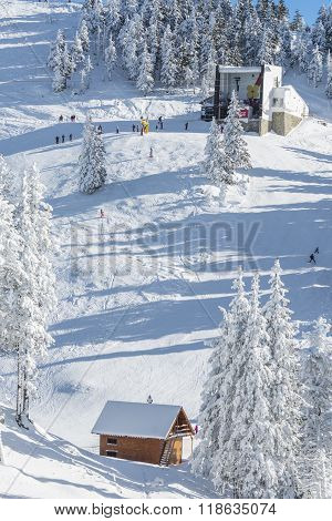 Mountain Cabin Set In A Valley Covered By Snow
