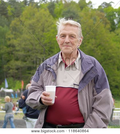 Senior drinking beer