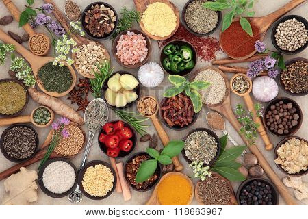 Large herb and spice food seasoning collection over natural hemp paper background.