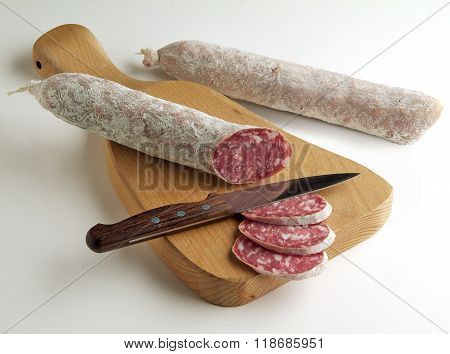 Salami Sliced On Cutting Board