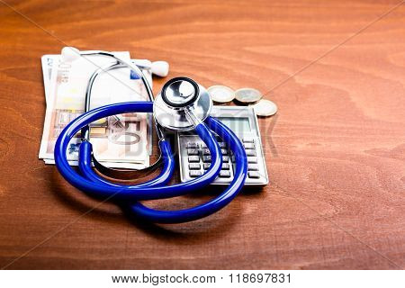 Stethoscope on a calculator and money