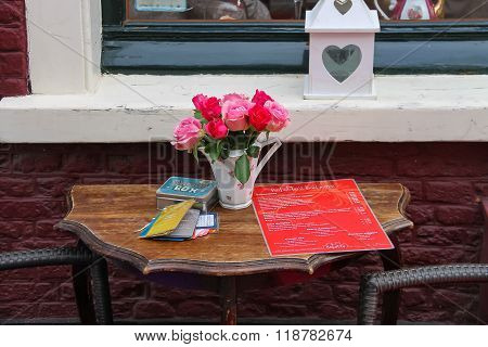 Outdoor Table With Roses In Vase And Menu Of Tea Rooms Bij Babette On Kruisstraat Street In Haarlem,