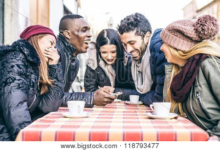 Friends Looking At Smartphone In A Bar