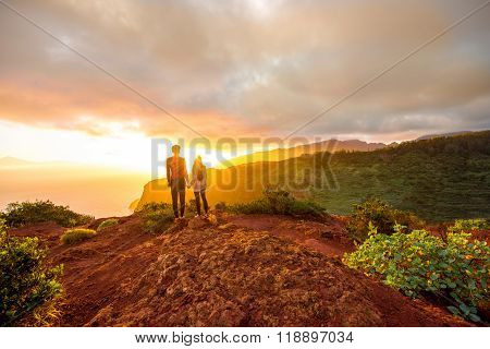 Couple enjoying beautiful sunrise