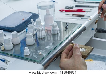 Dental Technician Applying Ceramics To Teeth In The Dental Model.