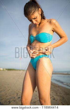 Bikini body goals.Pinching showing stomach belly fat.Looking disappointed.Self consciousness