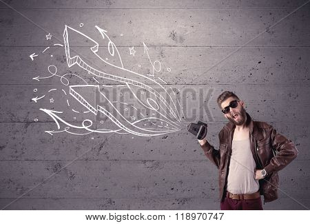 A hipster guy opening his point of view through looking a vintage camera concept with illustratied drawn arrows on urban wall